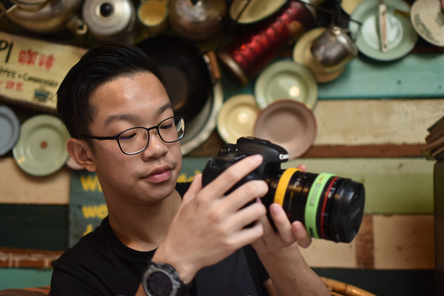 Chua Qin Peng holding a camera